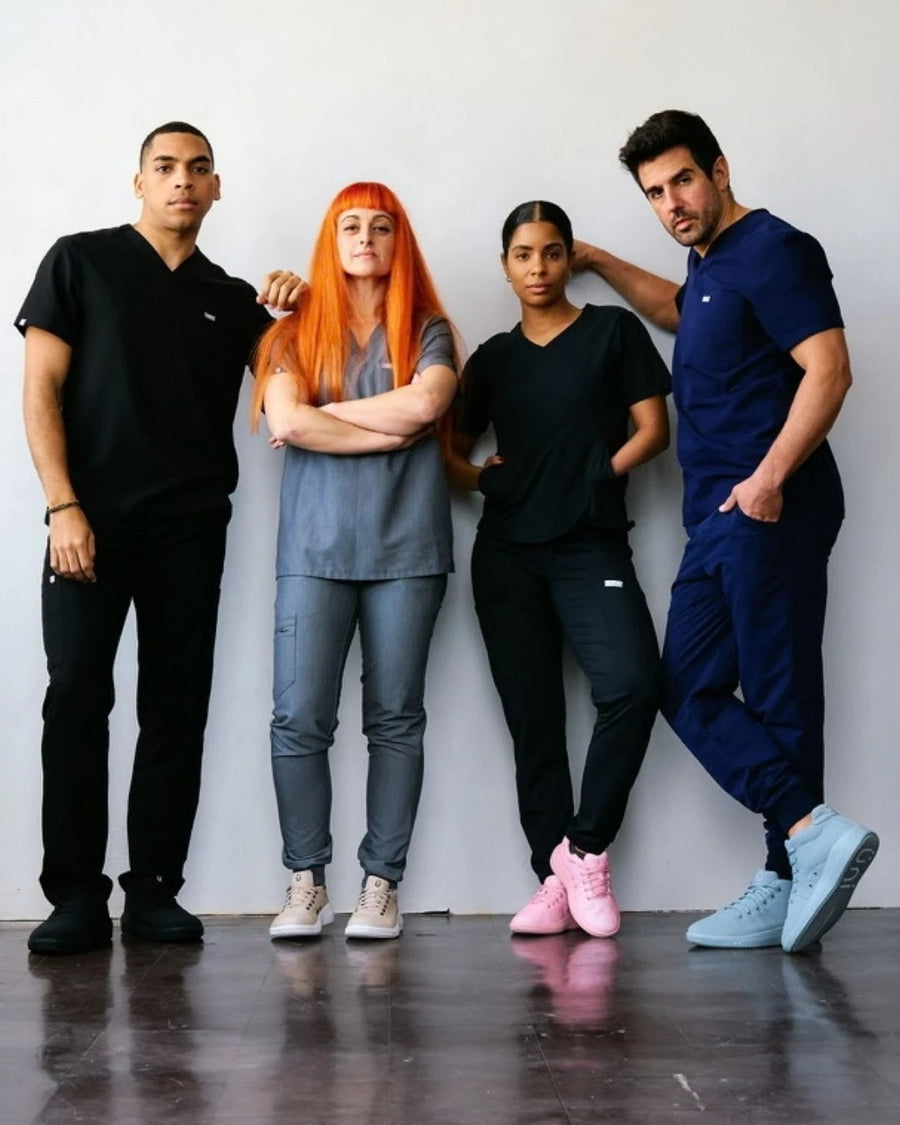 Four healthcare workers in scrubs wearing Perform in four colorways
