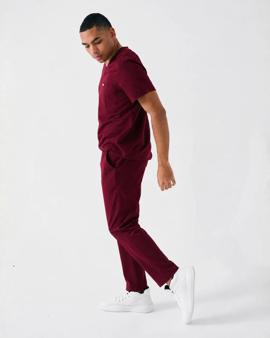 Healthcare worker in burgundy scrubs wearing Perform Whiteout Mid